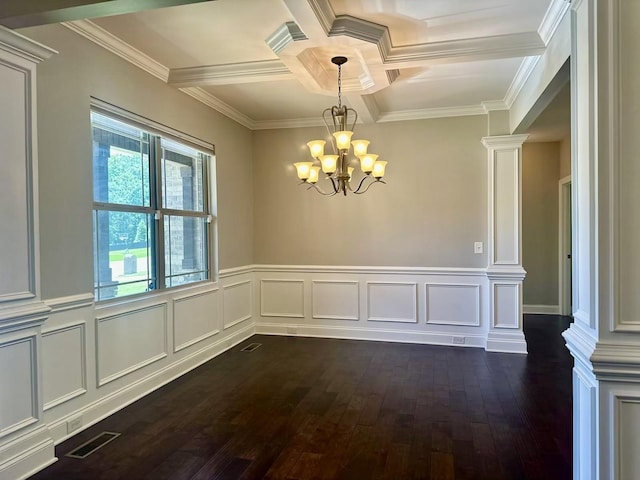 empty room with dark wood-type flooring, coffered ceiling, an inviting chandelier, ornamental molding, and beam ceiling