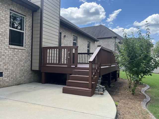 view of side of home featuring a patio and a deck