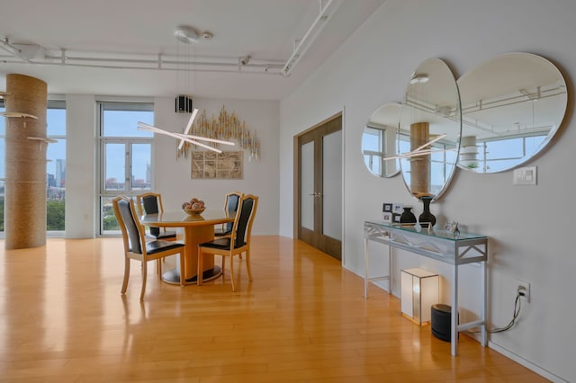 dining room with french doors and light wood-type flooring