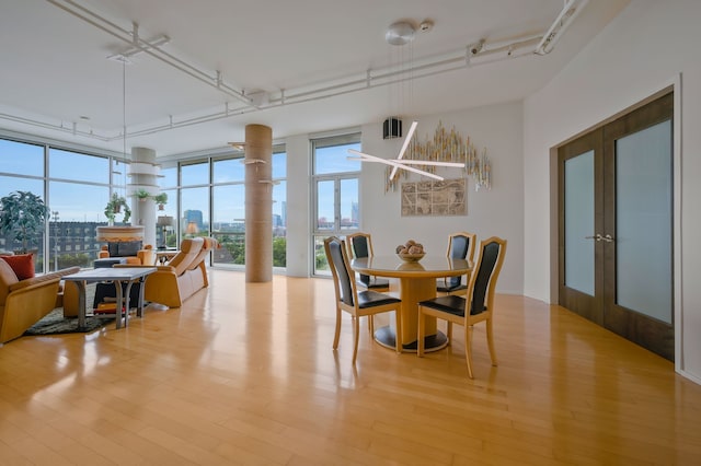 dining room with light hardwood / wood-style flooring and french doors