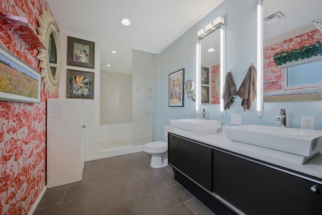 bathroom with a shower, tile patterned flooring, dual vanity, and toilet