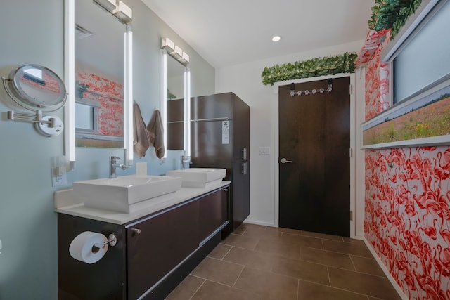 bathroom with tile patterned flooring and double vanity