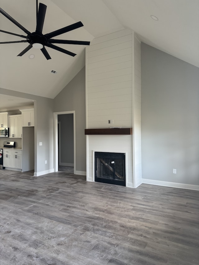 unfurnished living room featuring hardwood / wood-style floors, ceiling fan, a fireplace, and high vaulted ceiling