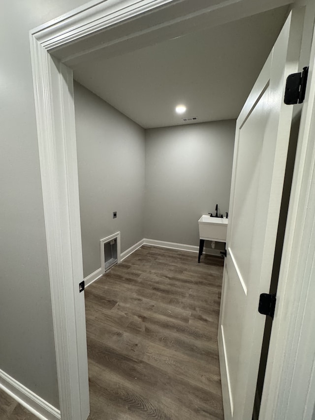 laundry room featuring electric dryer hookup and dark hardwood / wood-style floors