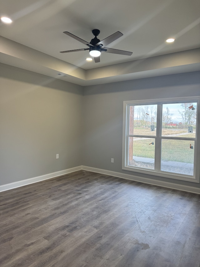 unfurnished room featuring ceiling fan and dark wood-type flooring