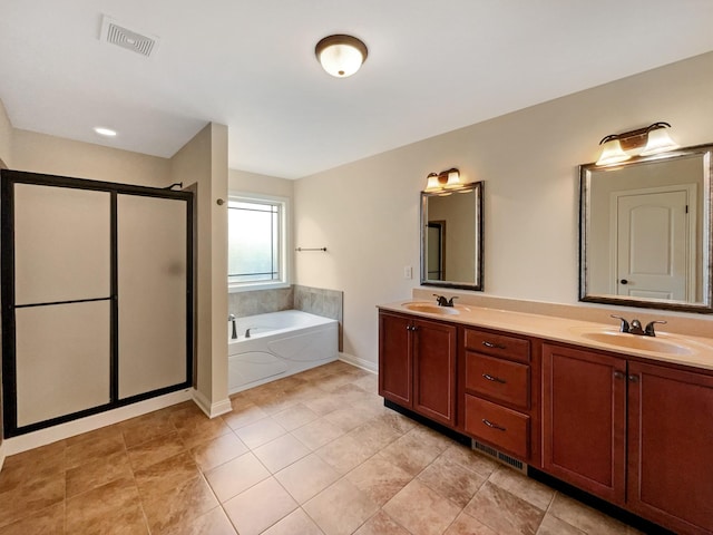 bathroom with tile patterned floors, vanity, and shower with separate bathtub