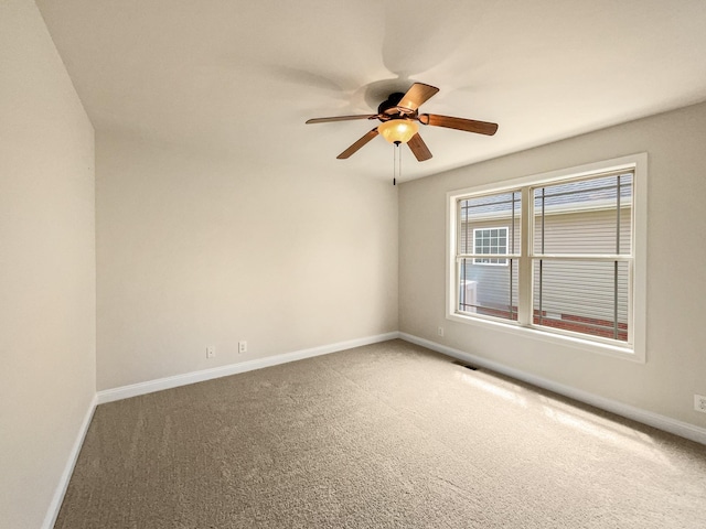 carpeted empty room featuring ceiling fan