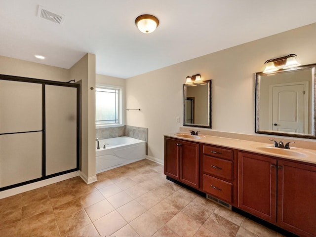 bathroom with tile patterned floors, vanity, and separate shower and tub