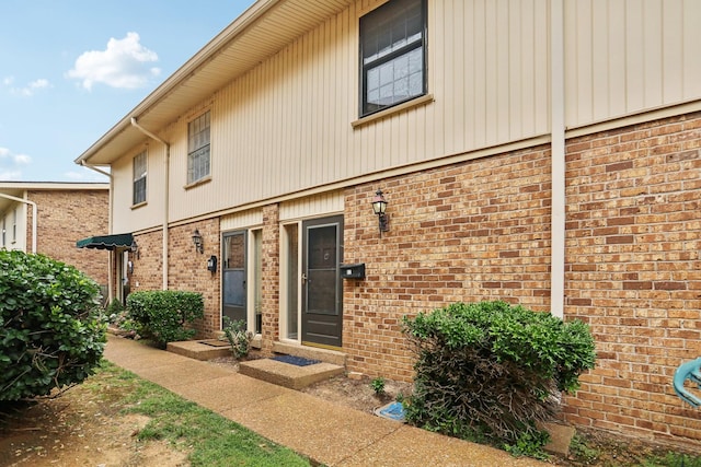 entrance to property with brick siding