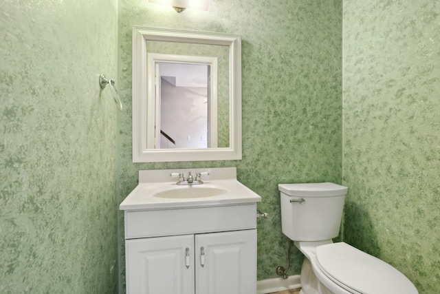 bathroom with toilet and large vanity