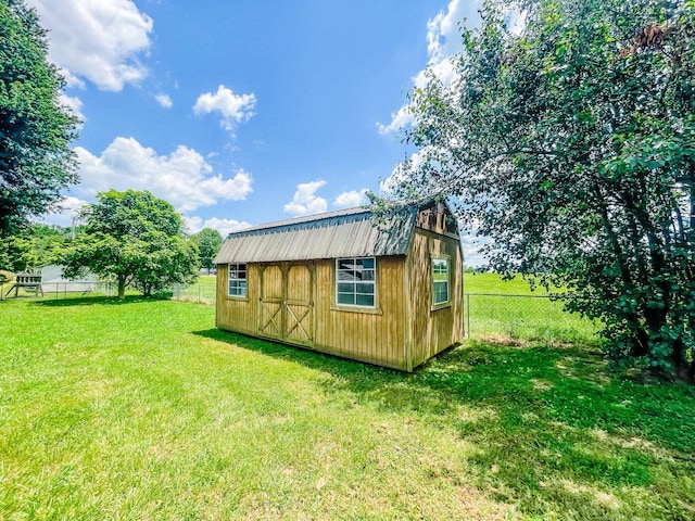 view of outdoor structure featuring a lawn