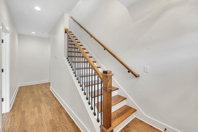 stairs with hardwood / wood-style floors