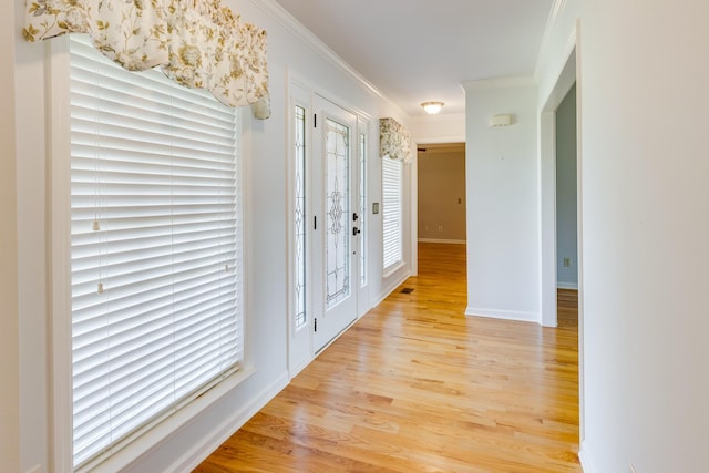 corridor featuring light hardwood / wood-style flooring and ornamental molding