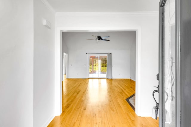 unfurnished living room with wood-type flooring, ceiling fan, and crown molding