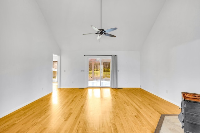 unfurnished living room featuring ceiling fan, light hardwood / wood-style floors, and high vaulted ceiling