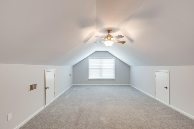 additional living space featuring ceiling fan, light carpet, and vaulted ceiling