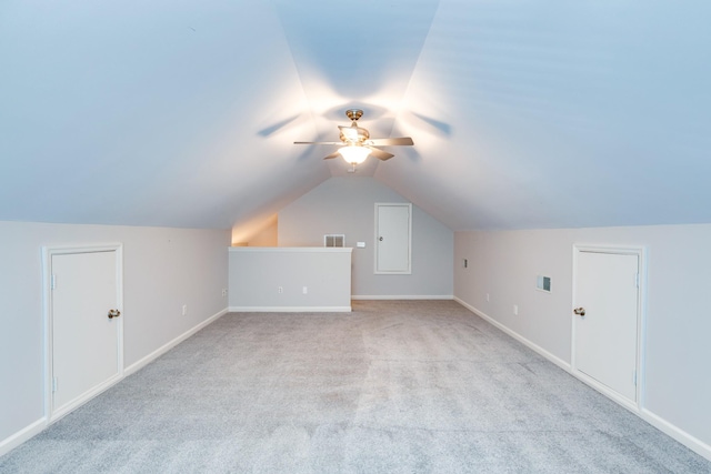 additional living space with ceiling fan, light carpet, and lofted ceiling