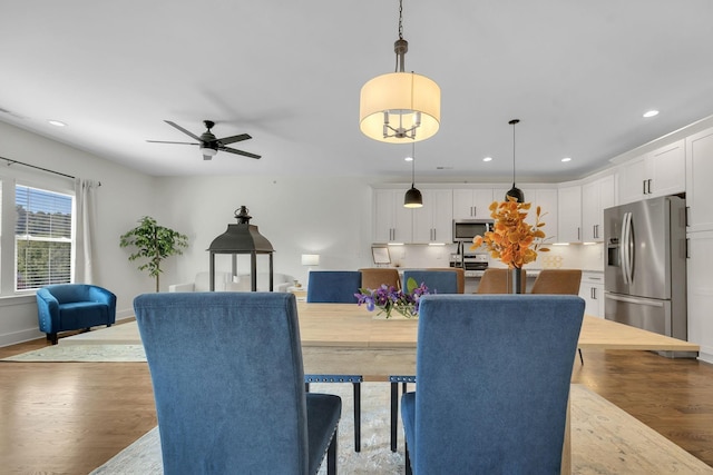 dining area with light hardwood / wood-style floors and ceiling fan