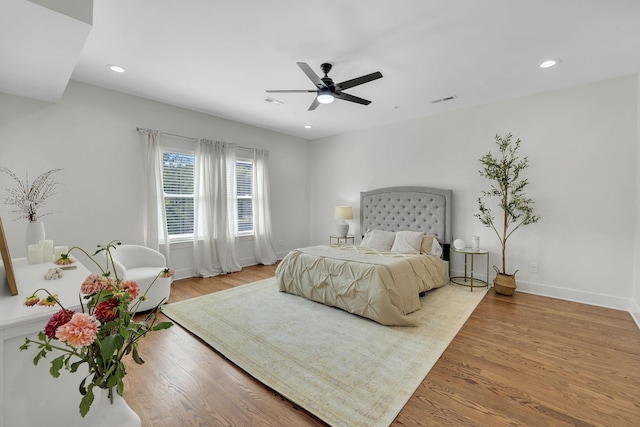 bedroom with ceiling fan and light hardwood / wood-style flooring