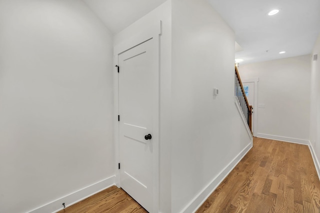 corridor with light hardwood / wood-style floors