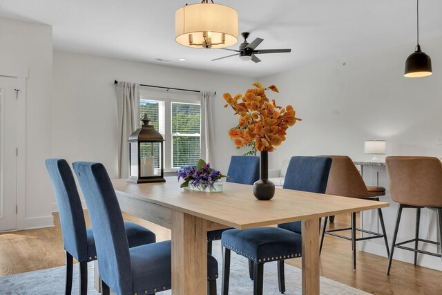 dining space featuring ceiling fan and light hardwood / wood-style flooring