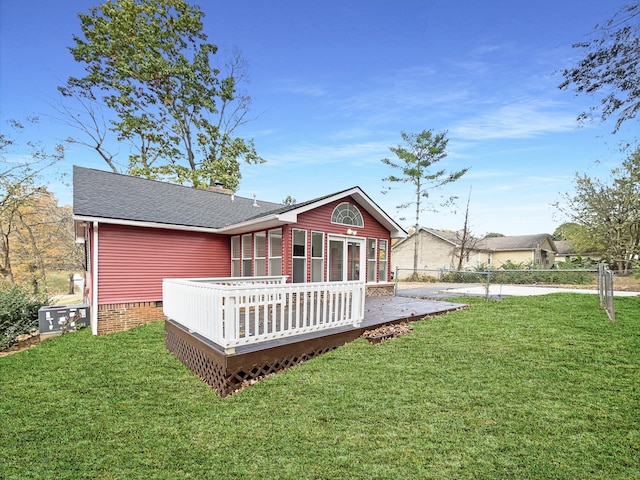 rear view of house featuring a deck, a yard, and a patio area