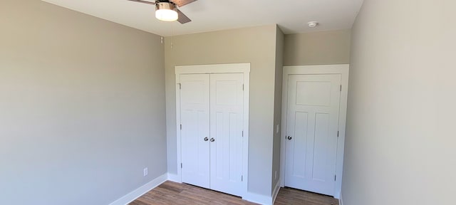 unfurnished bedroom with a closet, ceiling fan, and hardwood / wood-style flooring