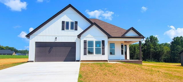 modern farmhouse with a garage and a front lawn