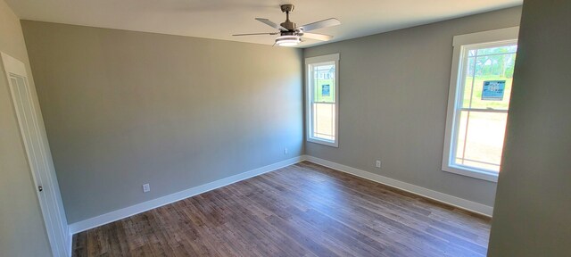 empty room featuring ceiling fan, a healthy amount of sunlight, and hardwood / wood-style flooring