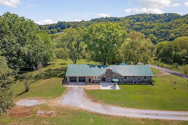 bird's eye view with a wooded view