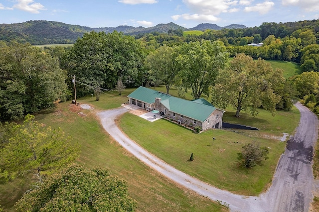 birds eye view of property with a mountain view and a forest view