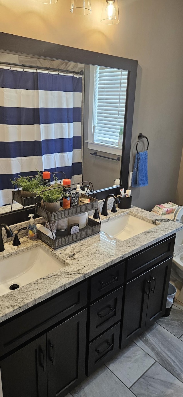 bathroom with tile patterned floors and vanity