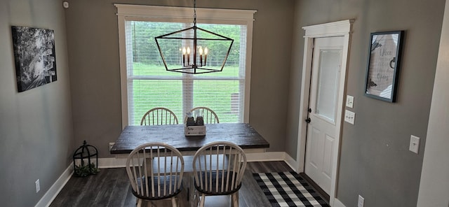 dining area featuring a chandelier and dark wood-type flooring