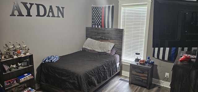 bedroom with hardwood / wood-style floors