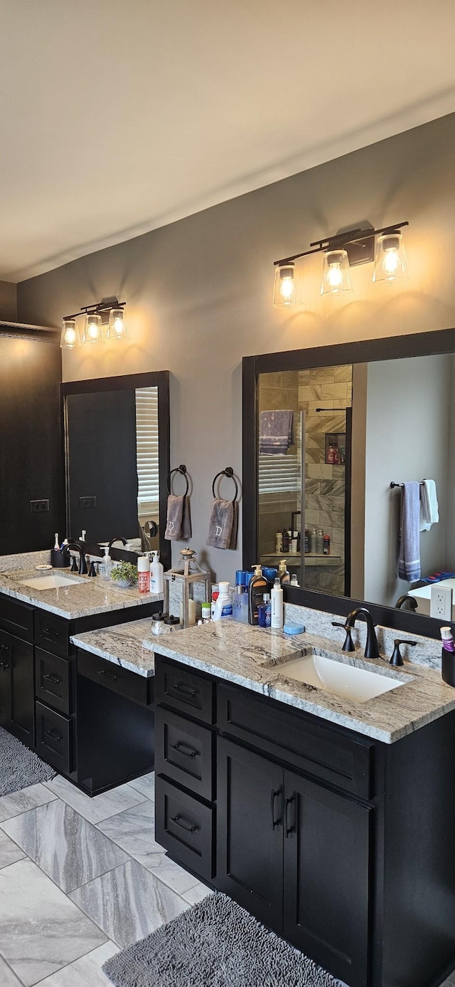 bathroom featuring a shower and vanity