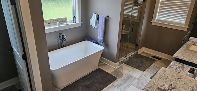 bathroom featuring shower with separate bathtub, vanity, and tile patterned floors