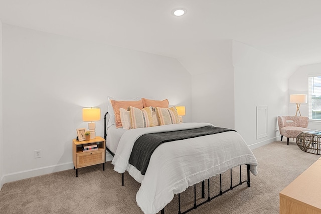 carpeted bedroom with vaulted ceiling