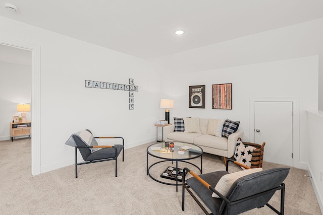 carpeted living room with vaulted ceiling