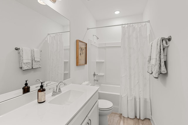 full bathroom with hardwood / wood-style floors, vanity, toilet, and shower / bathtub combination with curtain