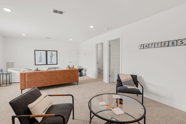 sitting room featuring light colored carpet