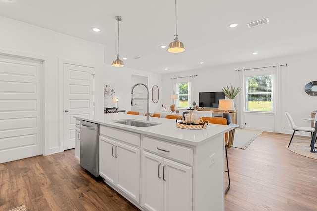 kitchen with dishwasher, sink, an island with sink, dark hardwood / wood-style flooring, and white cabinetry