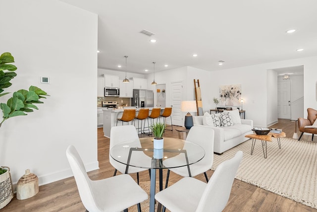 dining space with light wood-type flooring