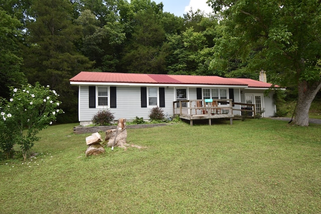 ranch-style house with a deck and a front yard