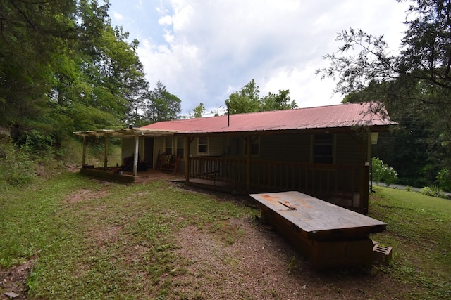 rear view of house with a yard