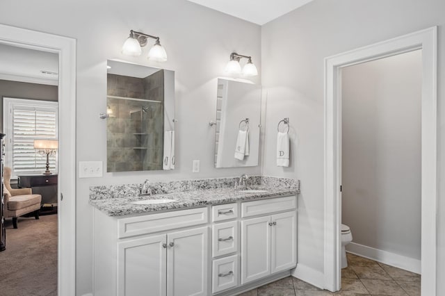 bathroom with tile patterned floors, vanity, toilet, and walk in shower