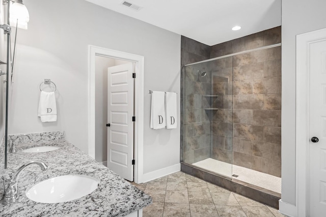 bathroom with tile patterned floors, sink, and a shower with door