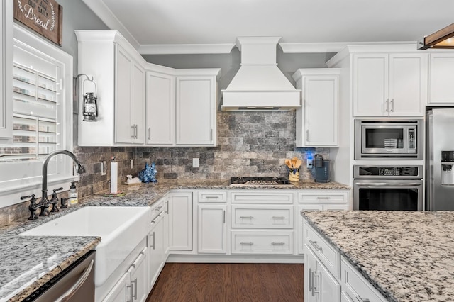 kitchen featuring white cabinets, sink, stainless steel appliances, and custom exhaust hood