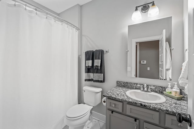 bathroom featuring tile patterned floors, vanity, and toilet