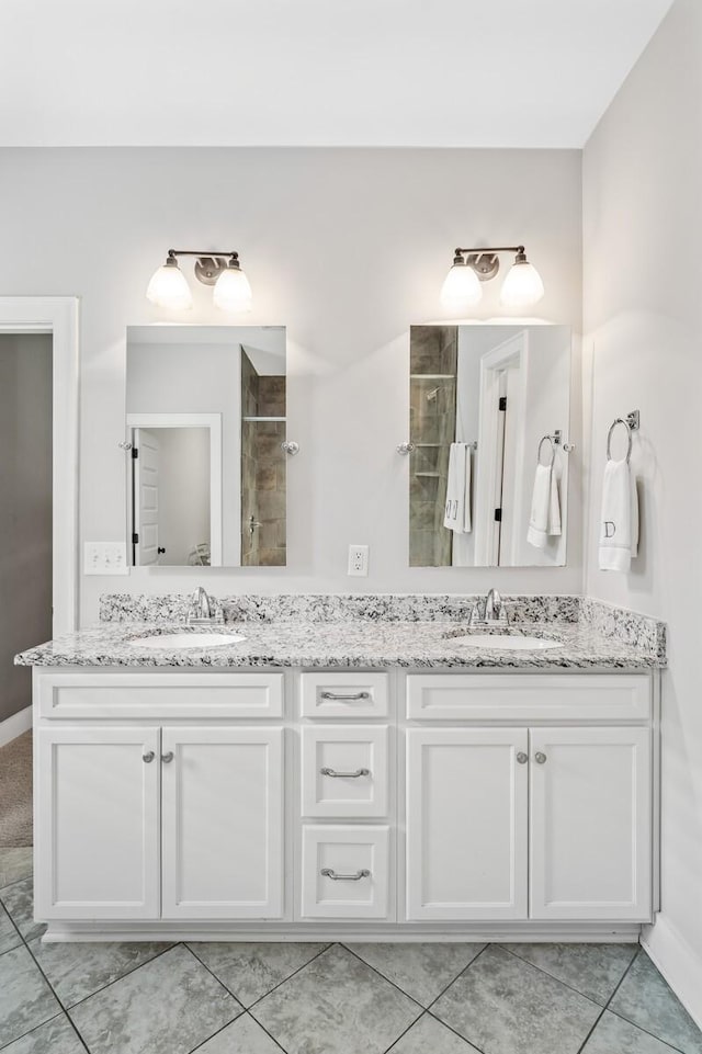 bathroom featuring tile patterned floors, vanity, and walk in shower