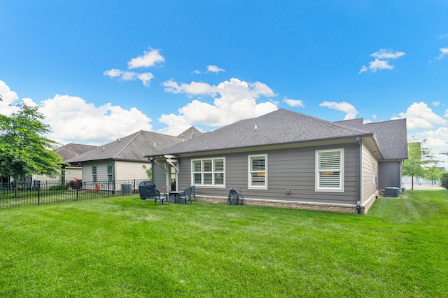 back of house featuring a lawn and central AC unit